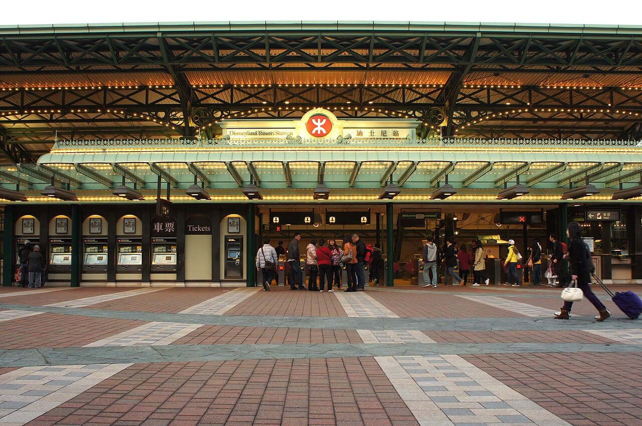 Disneyland Resort MTR station entrance with ticket machines and station signs.