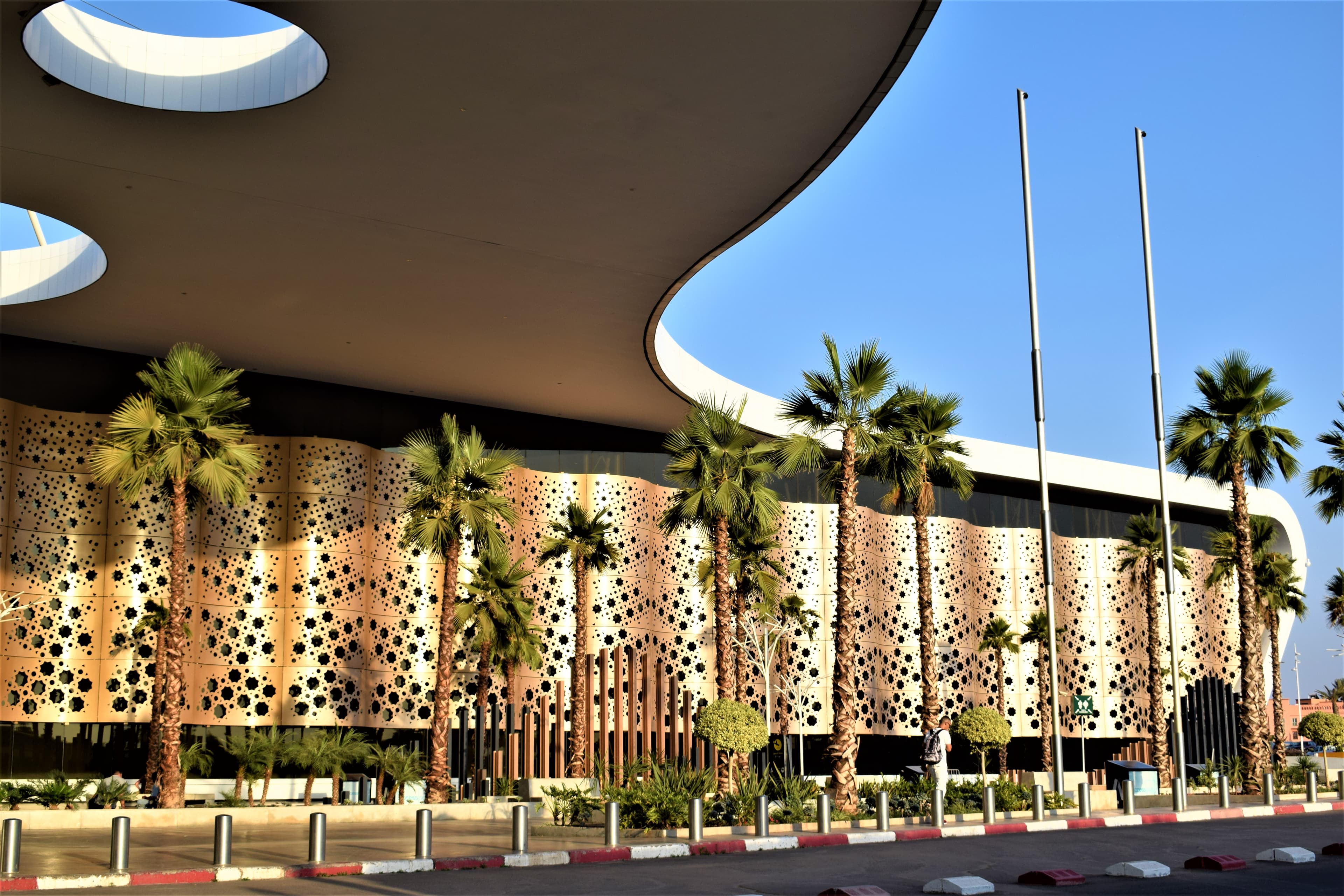 Marrakech-Menara Airport exterior with patterned facade and palm trees
