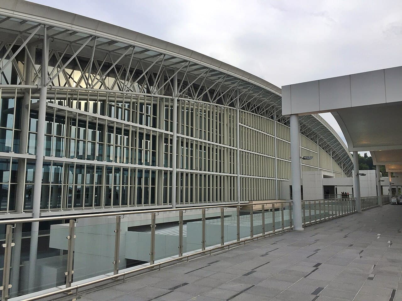 Glass facade and covered walkway at the passenger terminal of Brunei International Airport.