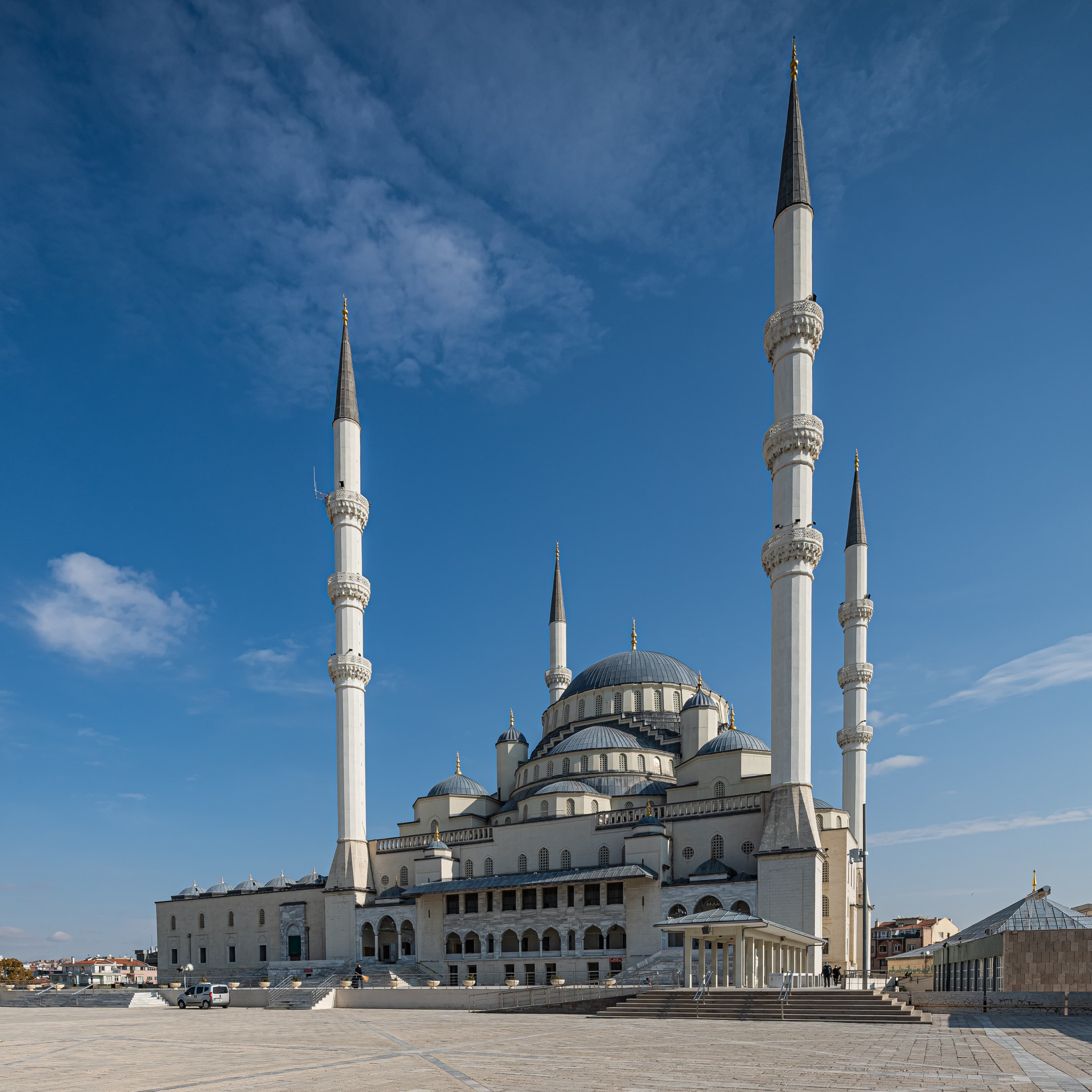 White stone facade, domes and minarets of Kocatepe Mosque in Ankara under a blue sky