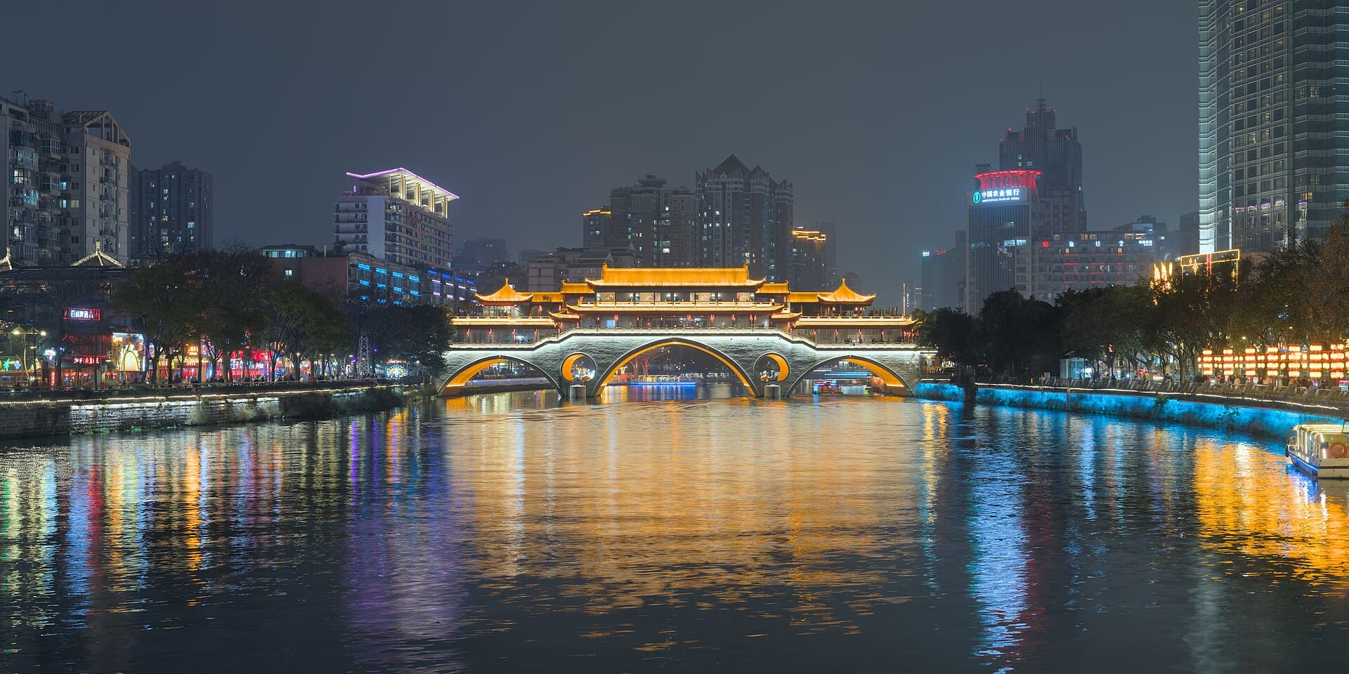 Anshun Bridge illuminated above the Jin River in Chengdu at night.