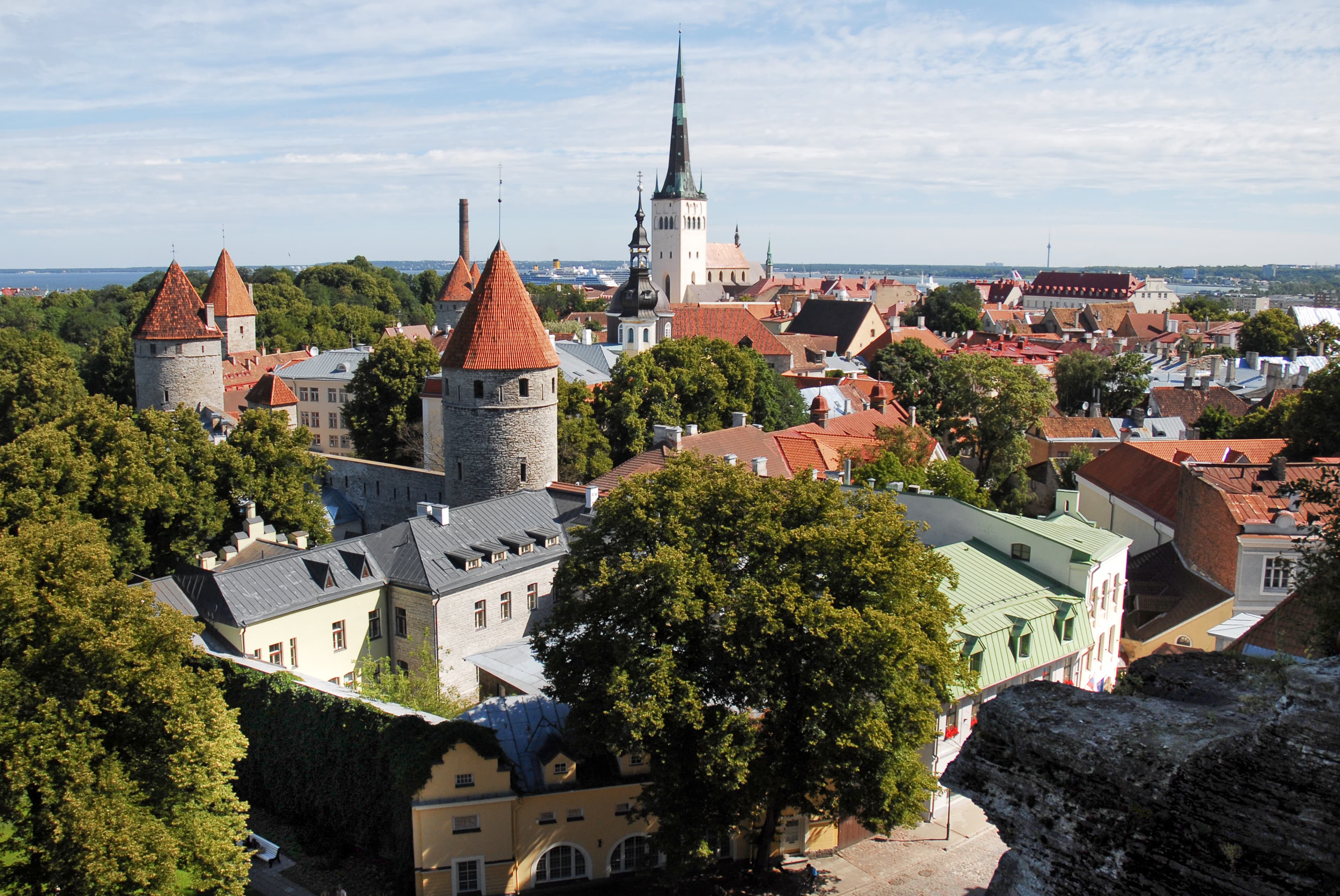 Red-roofed city-wall towers and St Olaf’s Church in Tallinn’s Old Town