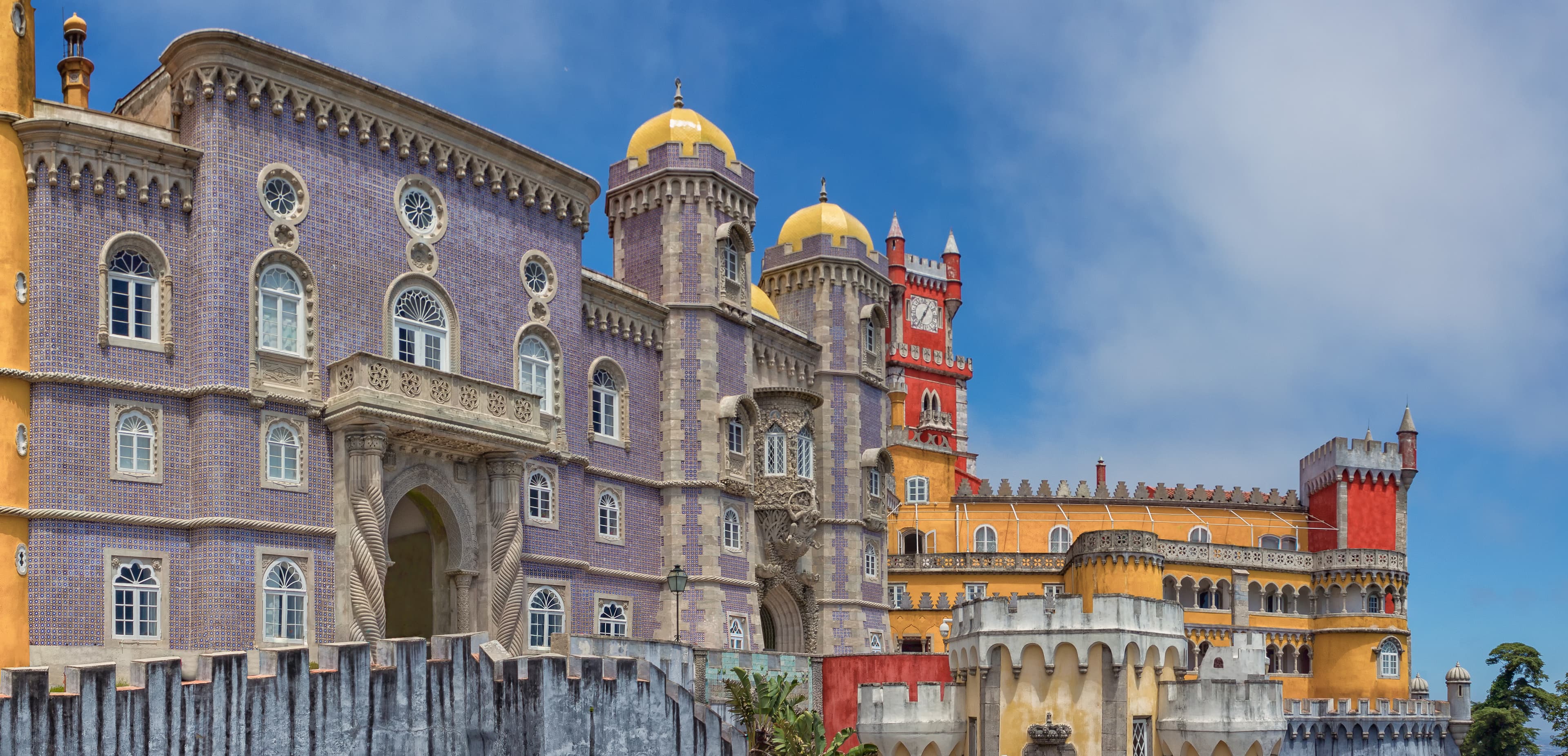 Coloured yellow and red towers and tiled facade of Pena Palace in Sintra