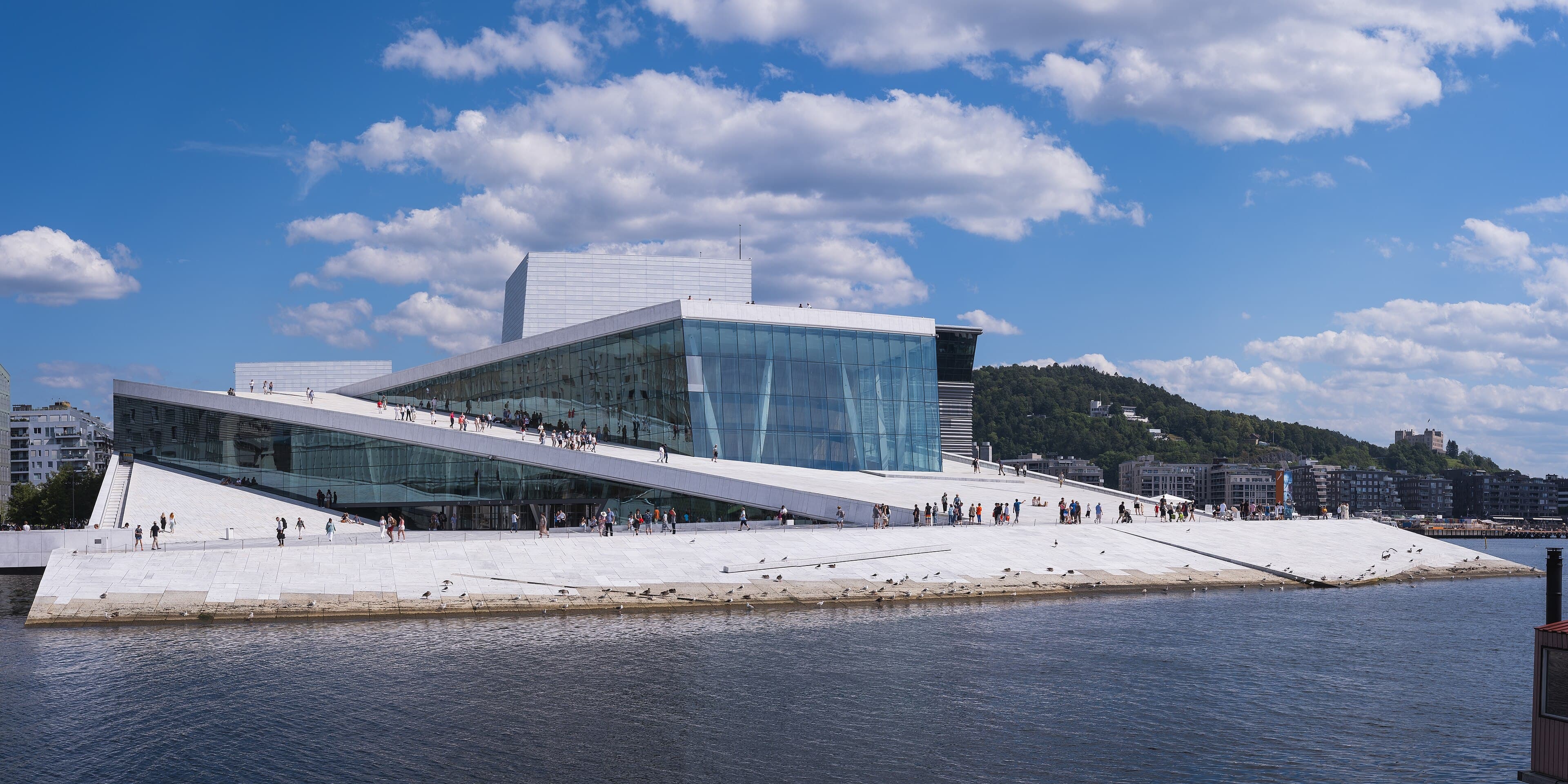 Oslo Opera House beside the waterfront under a blue sky