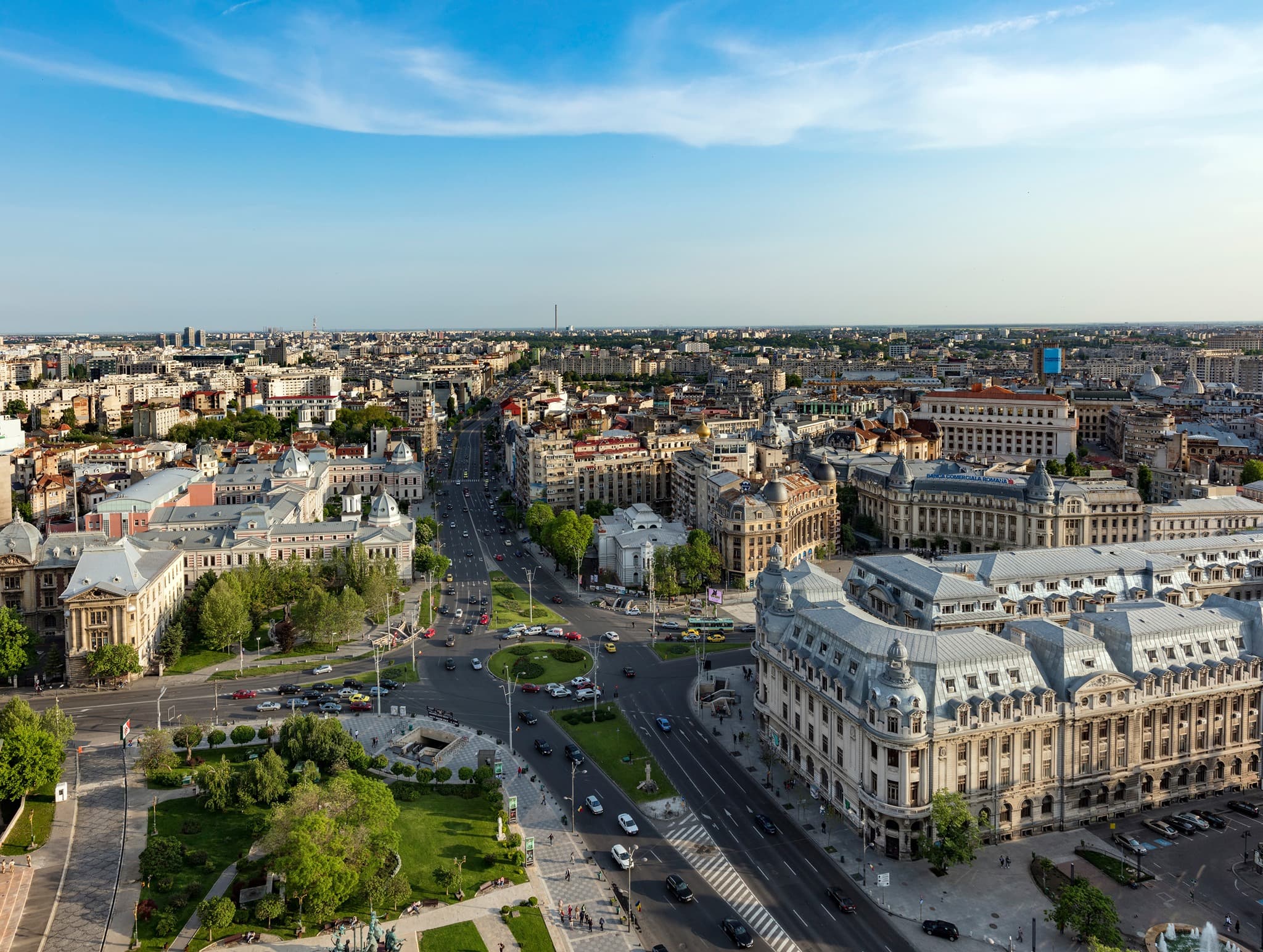 University Square and surrounding city-centre buildings in Bucharest under a blue sky