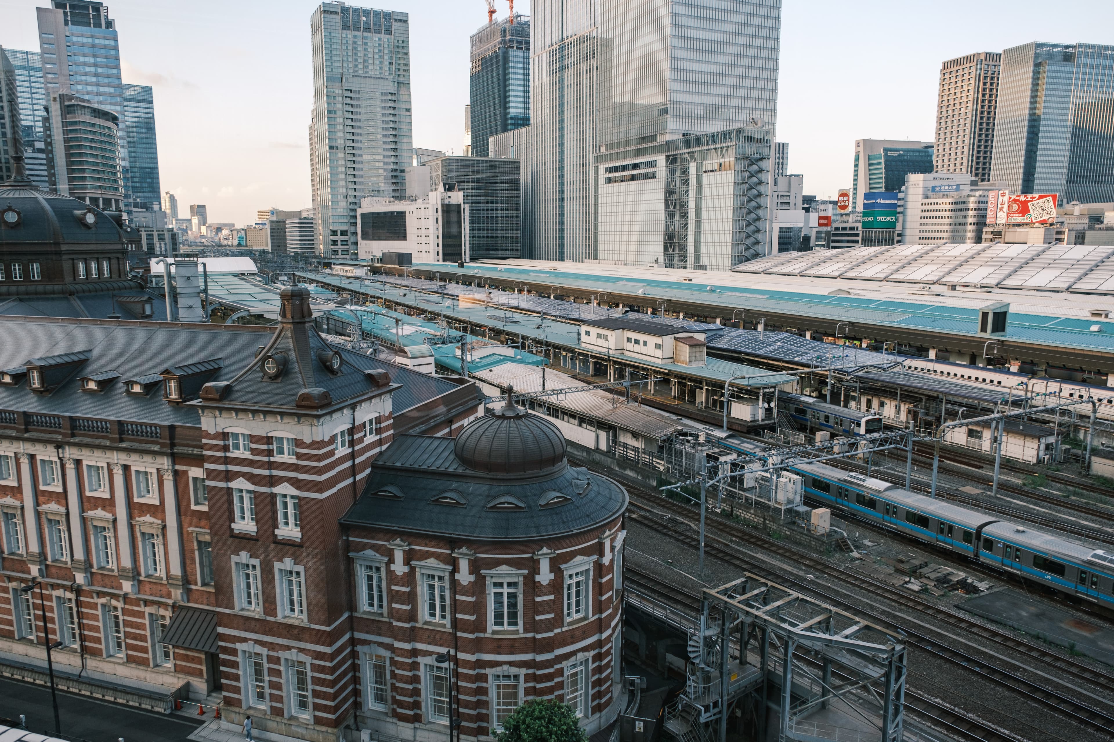 Tokyo Station’s brick building, railway tracks and surrounding high-rise buildings.