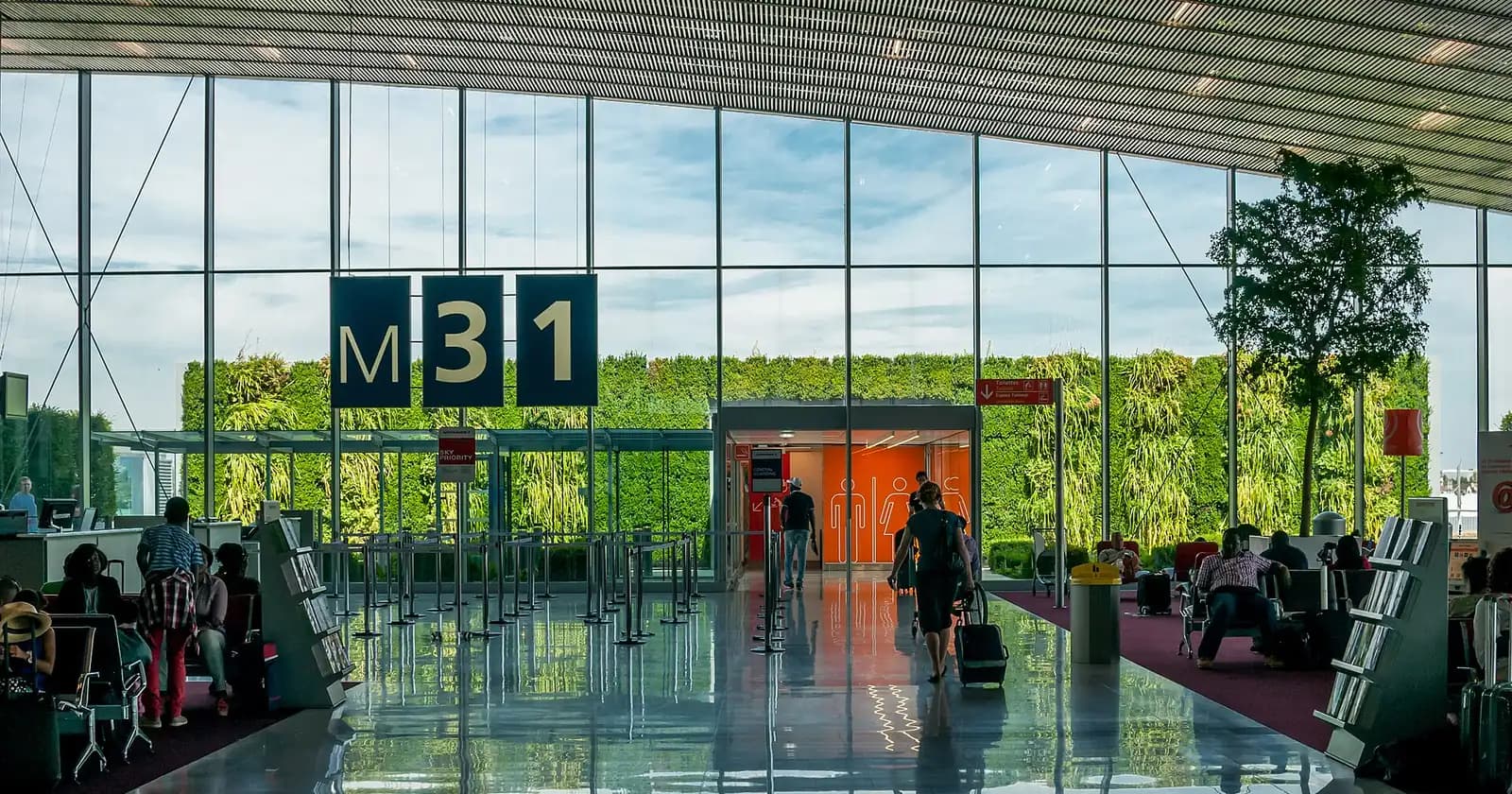 Seats and large windows in a concourse at Charles de Gaulle Airport